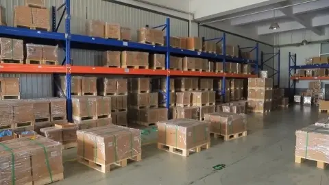Warehouse racking filled with boxed parts stock and palletised cartons
